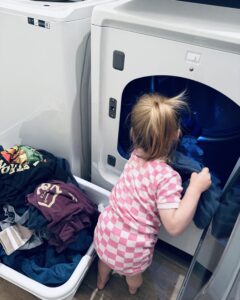 Toddler helping with laundry, stay at home mom life